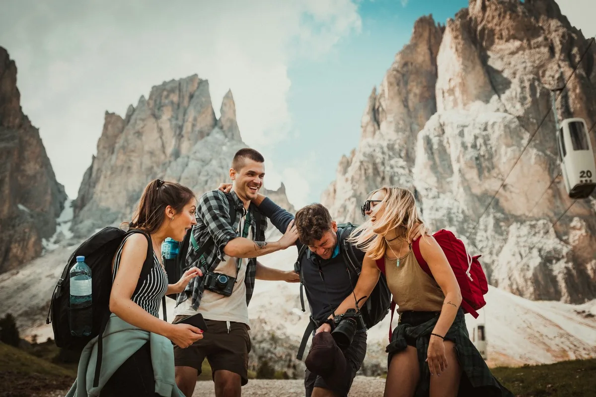 Friends laughing together on a mountain hike